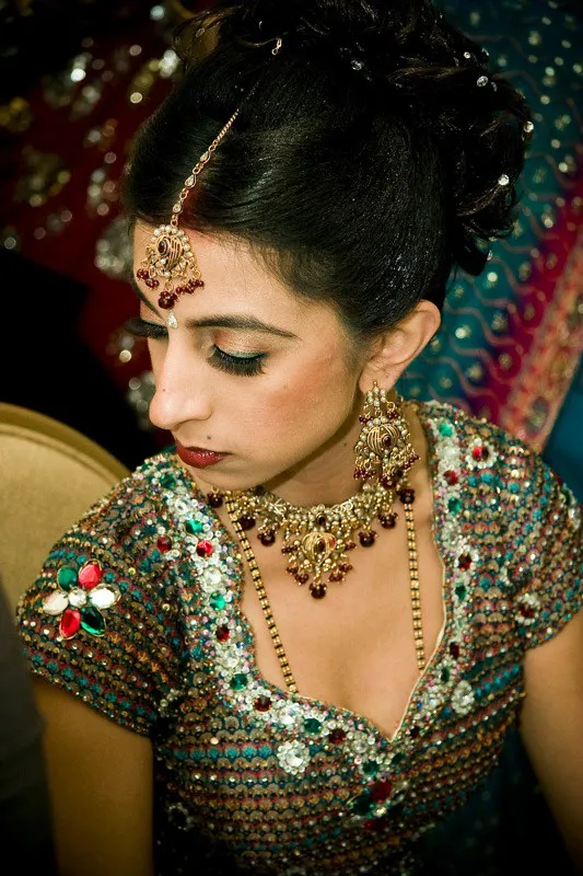 Bridal reception makeup with jeweled outfit and traditional accessories